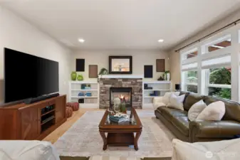 Spacious family room with another gas fireplace overlooking the backyard
