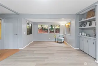 Bright and open entrance into living room with plenty of natural light.