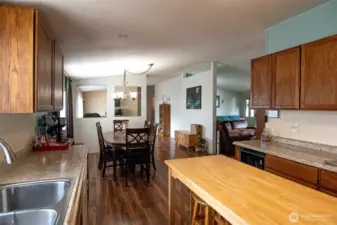 Kitchen opens to dining room.  Island stays. Double stainless sink.