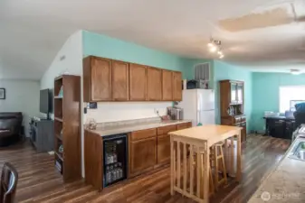 Kitchen features lots of cabinets and counter space. Room for a wine fridge.  To the right is the second dining area.  Laundry room leads to back yard.