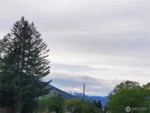 Snow capped peaks due West in distance from Driveway off of Twisp River River Road.