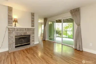 Brick-trimmed fireplace is wood-burning and Gold Pointe schedules annual cleanings for safety purposes.