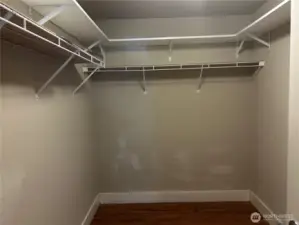 Large walk-in closet with overhead shelves