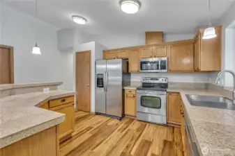 Open island kitchen with stainless steel appliances