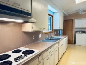 Spacious kitchen, walk-in pantry, all appliances stay with home, covered patio, vaulted ceilings, nod to midcentury modern, butcher-block countertop on peninsula