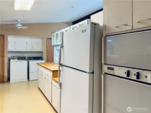 Kitchen with a butcher block peninsula, double oven, washer and dryer stay with home, refrigerator, all appliances stay with home