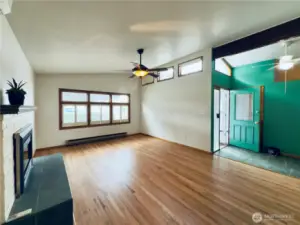 Living room and entryway of 3038 Louisiana St, Longview WA 98632, refinished hardwood floors, vaulted ceiling, natural light, fireplace, mini-split, ac/heating