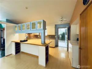Open floor plan allows access to dining room and kitchen with back door to covered patio and fenced backyard with apple tree and garden area