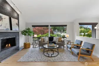 Great room with vaulted ceilings, wood burning fireplace, Lutron remote blinds