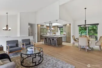 Great room with vaulted ceilings and open to chef inspired kitchen & dining area with professional appliances