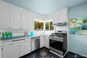 Plenty of cabinet space, tiled counters and stainless appliances.