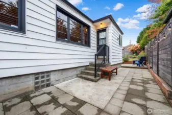 Private patio with string lighting and seating area—perfect for morning coffee, summer barbecues, or quiet evenings outdoors