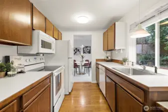 Functional kitchen with warm cabinetry and a fantastic view out the windows.
