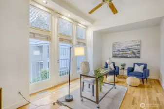 Light & bright with ceiling fans and big windows.