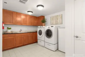 Laundry room has tons of storage space, including at closet at left that is not pictured.