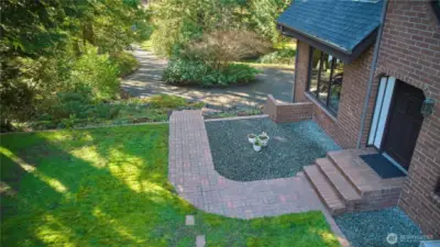 Brick walkway leading to front door. Front yard space.
