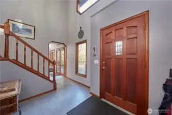 Inviting entry way with tile flooring and wood windows.
