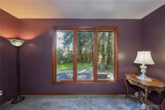 Formal living room looking out the windows to front yard.