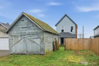 Brand new wood fence fully encloses the backyard.