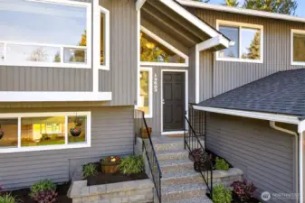 A covered entry with an easy approach from the driveway and a welcoming, protected front door landing. Clean lines, strong roof geometry, and modern trim details set the tone before you step inside. Raised planters and tidy hardscape create a polished first impression with low maintenance appeal.
