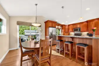 The dining area and kitchen connect seamlessly, with hardwood floors, vaulted ceiling height, and an easy flow to the deck for outdoor meals and summer grilling. Granite counters, generous workspace, and a breakfast bar create a true hub for everyday living, whether you’re hosting or keeping weeknights simple.