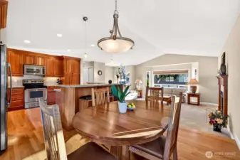 A wide open main level layout that keeps everyone together, kitchen, dining, and living spaces aligned for effortless entertaining. Vaulted ceilings and abundant natural light make the space feel expansive, while the fireplace anchors the living area for comfortable evenings at home.