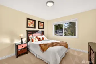 A bright, comfortable bedroom with a large window and a clean, neutral palette that pairs easily with any style. This space works well as a dedicated guest room, hobby room, or additional office, offering the versatility buyers value in a 4 bedroom layout.