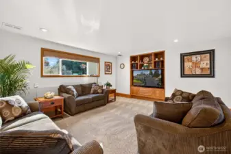 The lower level family room offers a large, comfortable footprint with recessed lighting and a built in media wall that creates a natural focal point. It’s an ideal setup for movie nights, game days, and a dedicated hangout space separate from the main level.