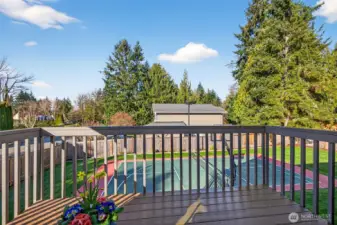 Deck access extends the main level living space outdoors, overlooking the fenced backyard and the sports court, an uncommon feature that adds lifestyle value on this 11,628 sf lot. Enjoy a private, evergreen backed setting that feels calm and established, perfect for grilling, entertaining, and everyday outdoor time.