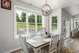 Custom light fixtures throughout. This lovely dining area is bright & open.