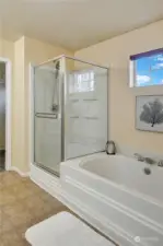 The soaking tub is the perfect place to relax, plus there is a glass enclosed shower.  The long vanity counter has two sinks, making it easy for two people to get ready at once.  The toilet is located in a separate room off the bathroom, for privacy.