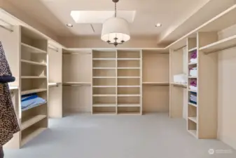 Owners' suite dressing room with skylight and plumbed for washer and dryer.