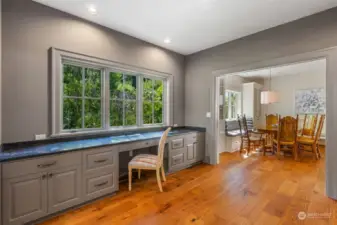 Built-in desk and shelving in the home office with a continuation of the French Oak flooring.