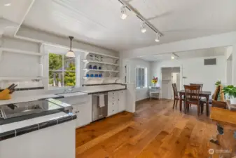 Enter the East wing of the home.  Here is the second kitchen all appointed with Kitchen Aid appliances.  It has it's own dining area, full bath and entrance to the home's family room.