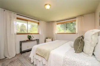 The comfortable Primary Bedroom offers plush new carpeting, pretty front yard views and built-in cedar closet & drawers.