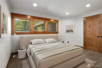 Spacious bedroom, light bright and trimmed with rich wooden trim and solid wood doors.