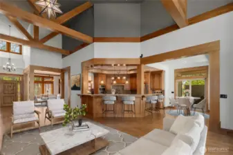 Expansive open-concept living drenched in natural light, with vaulted ceilings and panoramic windows that blur the line between indoor elegance and outdoor serenity.