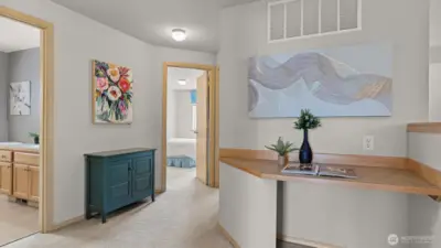 Spacious hallway upstairs with a built in Desk