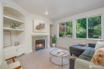 Large windows fill the family room with natural light, making it bright and welcoming.
