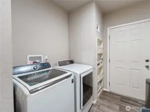 Laundry room with closeted hot water heater