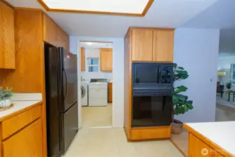 A pocket door provides access to the cheerful laundry next to kitchen. Laundry also features a walk-in pantry and a half bath.