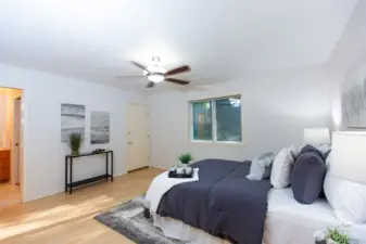 Spacious primary suite offers 3/4 ensuite bath and roomy walk-in closet.