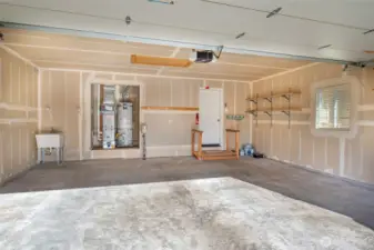 Oversized garage with newer recently serviced furnace and attic access ladder