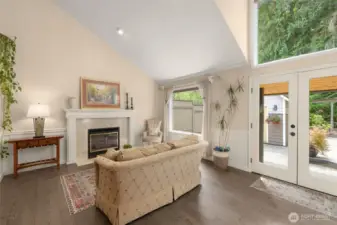 Vaulted ceilings in Living room filled with light from massive windows and French doors to the back oasis!
