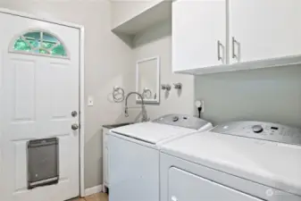 Laundry room with door to backyard