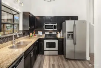 Chef's kitchen includes stainless steel appliance package and ample granite countertop space!