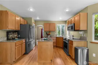 Open kitchen with eat in area with access to family room and deck.
