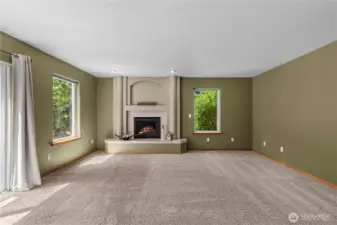 Family room with fireplace and access to  deck and private back yard.