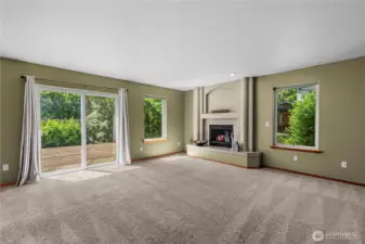 Family room with fireplace and access to  deck and private back yard.