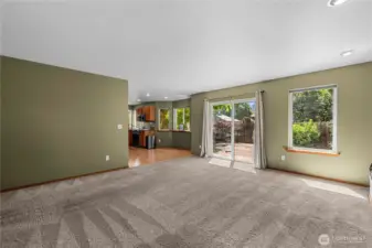 Family room with fireplace and access to  deck and private back yard.